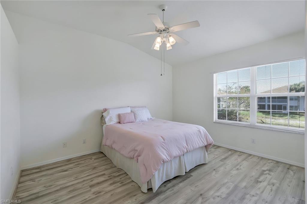 6812 Satinleaf Road South, Unit 204 Naples, FL 34109 - Photo 24 of 39 a bedroom with a large bed and a window
