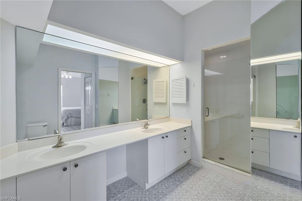 6812 Satinleaf Road South, Unit 204 Naples, FL 34109 - Photo 26 of 39 a bathroom with a double vanity sink mirror and double