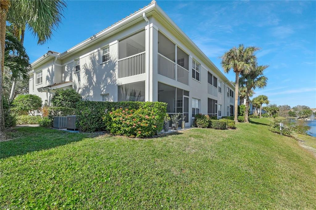 6812 Satinleaf Road South, Unit 204 Naples, FL 34109 - Photo 32 of 39 a view of a house with a yard
