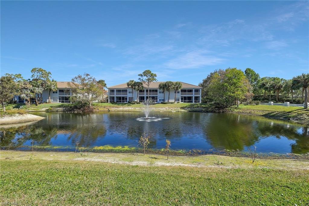 6812 Satinleaf Road South, Unit 204 Naples, FL 34109 - Photo 33 of 39 a view of a lake with houses in the background