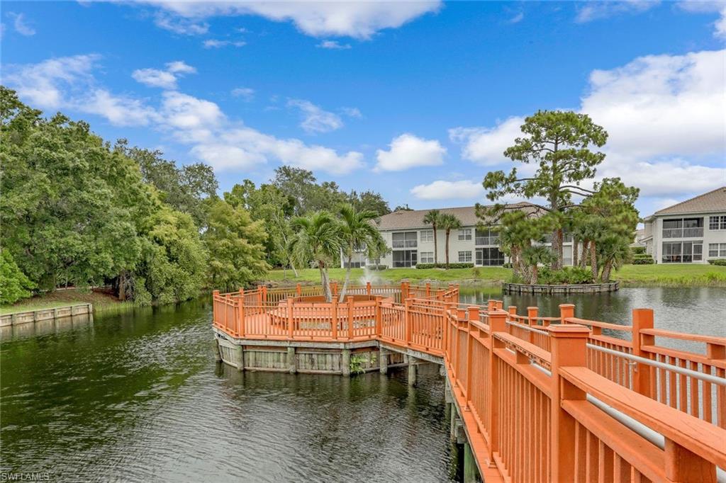 6812 Satinleaf Road South, Unit 204 Naples, FL 34109 - Photo 37 of 39 a balcony with chairs and lake view