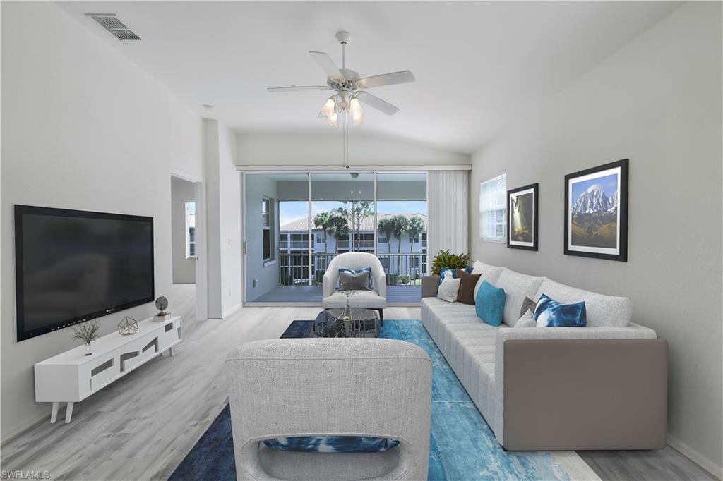 6812 Satinleaf Road South, Unit 204 Naples, FL 34109 - Photo 4 of 39 a living room with furniture and a flat screen tv
