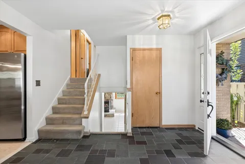 a view of an entryway with wooden floor and a front door
