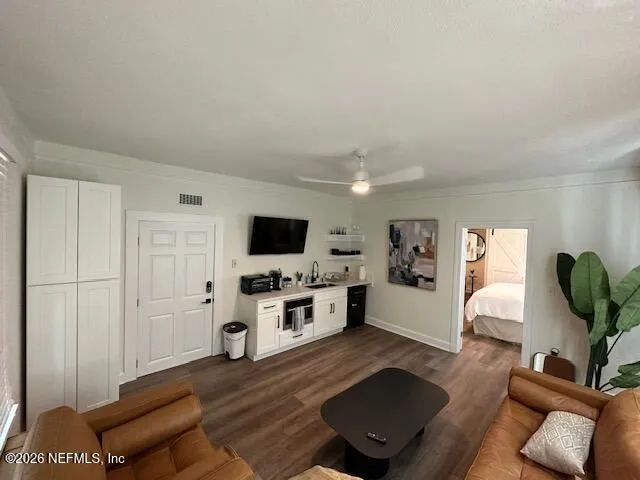 a view of a big room with windows and entryway