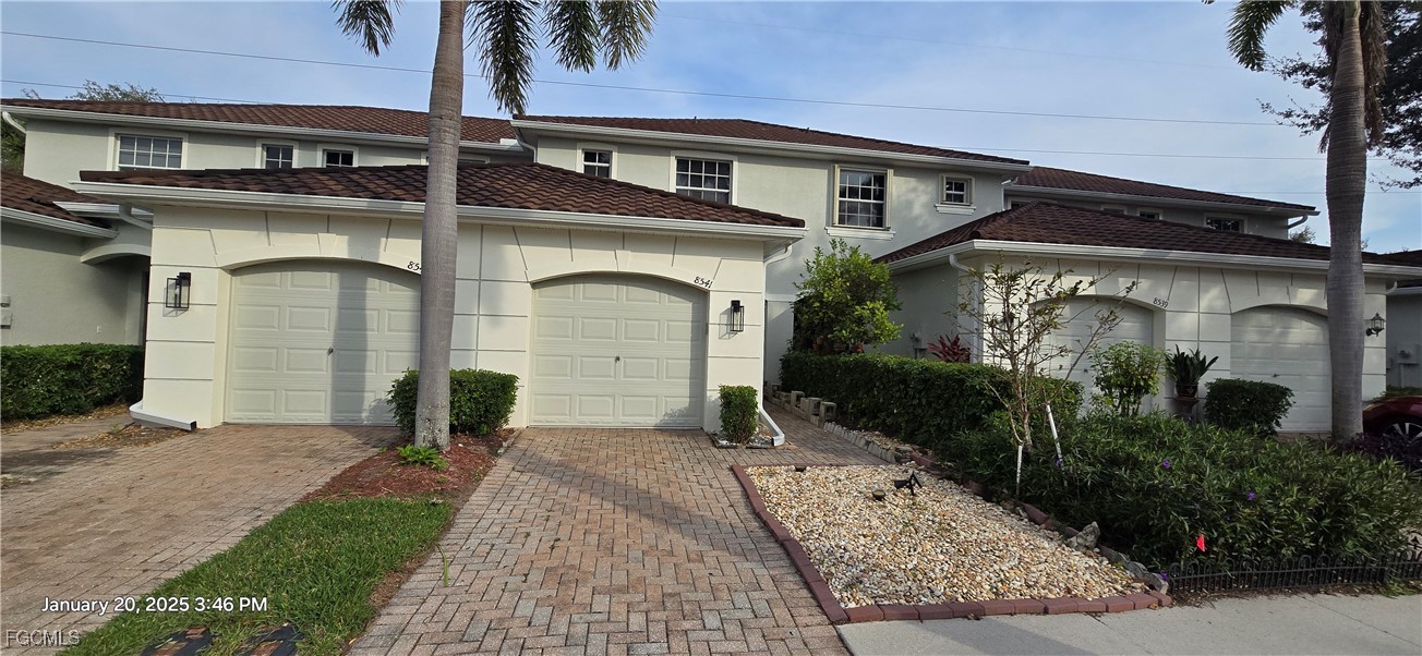 8541 Athena Court Lehigh Acres, FL 33971 - Photo 31 of 47 a front view of a house with garden