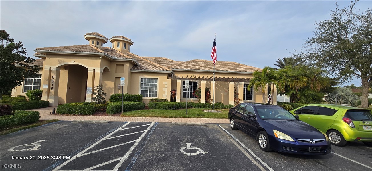 8541 Athena Court Lehigh Acres, FL 33971 - Photo 33 of 47 a front view of a house with garden