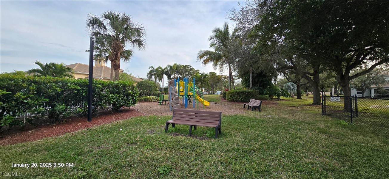 8541 Athena Court Lehigh Acres, FL 33971 - Photo 40 of 47 a wooden bench sitting in the middle of a park