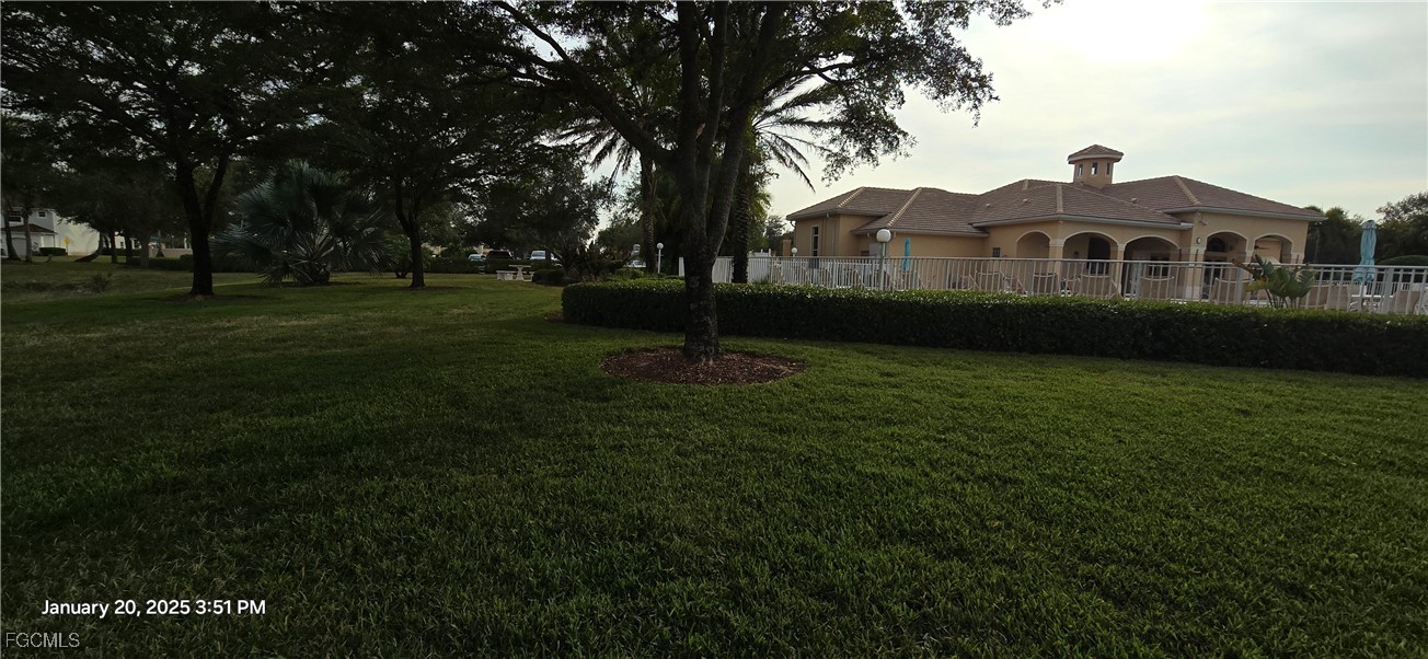 8541 Athena Court Lehigh Acres, FL 33971 - Photo 43 of 47 a front view of a house with a yard
