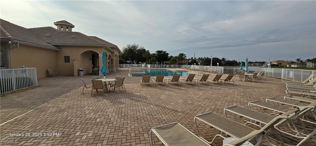 8541 Athena Court Lehigh Acres, FL 33971 - Photo 44 of 47 a view of a patio with a table and chairs