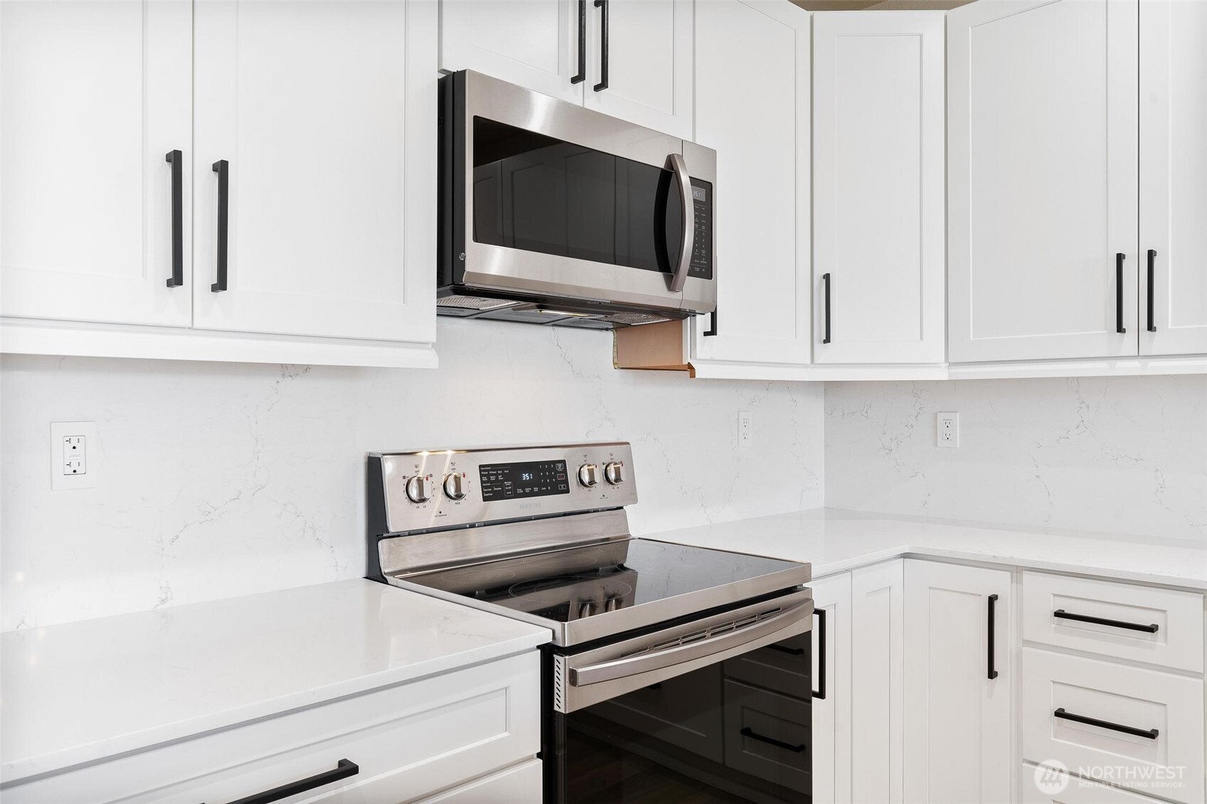 14915 38th Drive Southeast, Unit F3011 Bothell, WA 98012 - Photo 5 of 40 a kitchen with white cabinets and appliances