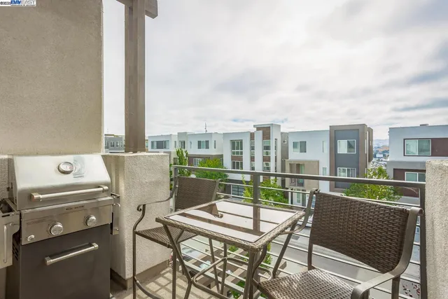 a view of a balcony with a table and chairs