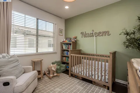 a bedroom with furniture and a window