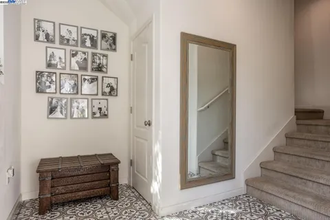a room with a couch and a book shelf