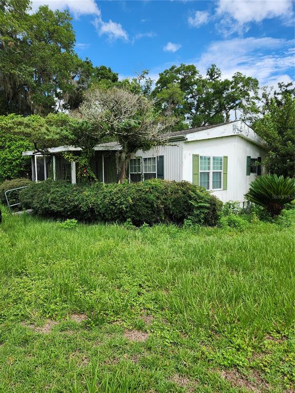 9228 Northeast Jacksonville Road Anthony, FL 32617 - Photo 3 of 8 front view of house with a yard