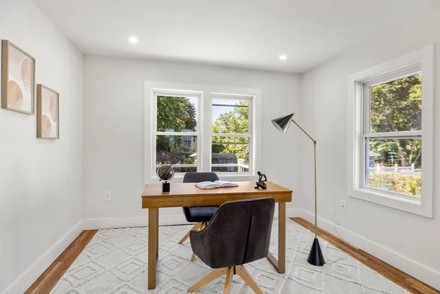 a view of a workspace with furniture and window