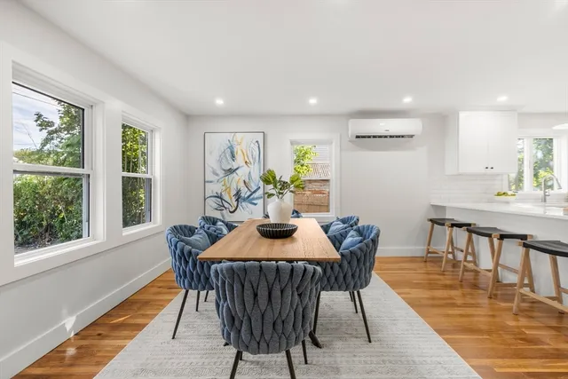 a dining room with furniture and wooden floor