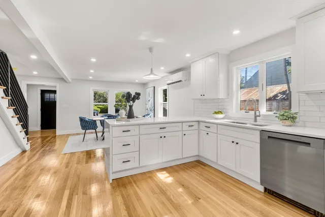 a large white kitchen with cabinets