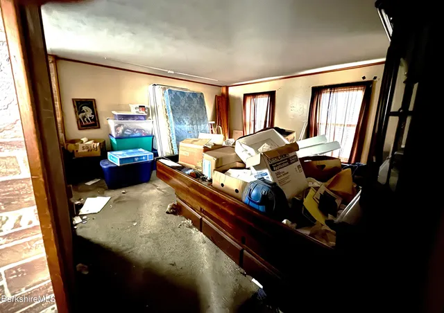 a bed room with furniture and a window