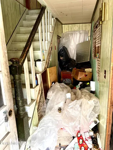 a bedroom with bed and glass door
