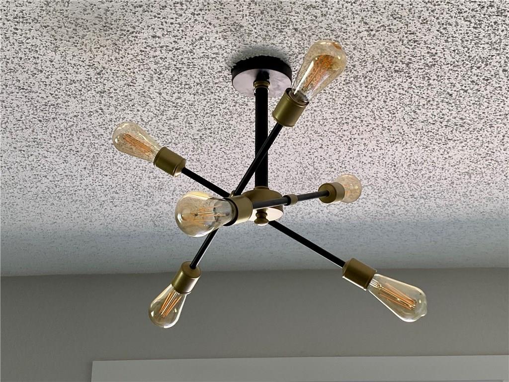 1715 Shadowview Drive, Unit B Austin, TX 78758 - Photo 21 of 28 An artistic sputnik chandelier provides generous lighting to this interior space.