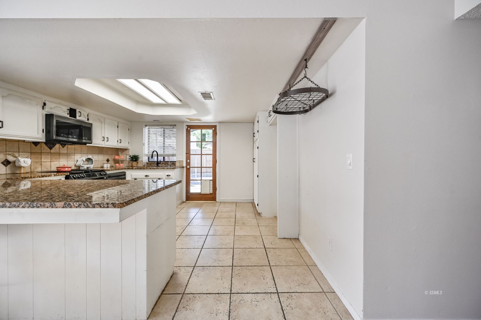 815 Walker Lane Ridgecrest, CA 93555 - Photo 4 of 23 a kitchen with granite countertop a stove a sink and a refrigerator