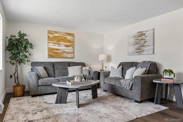 a living room with furniture and a potted plant