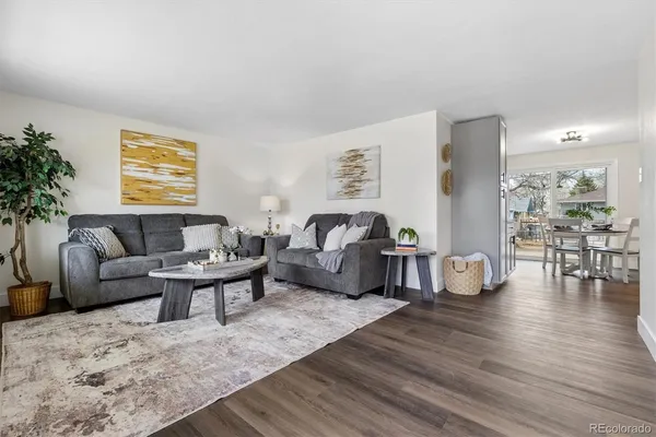 a living room with furniture and wooden floor