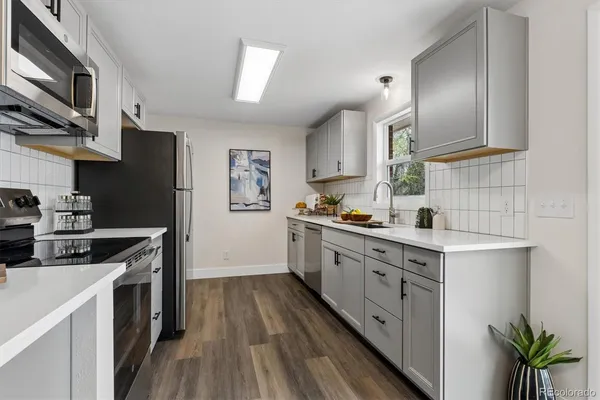 a kitchen with stainless steel appliances granite countertop a sink stove and refrigerator