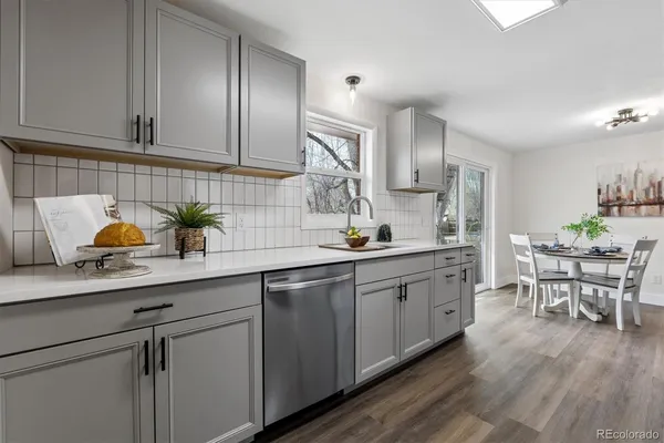 a kitchen with sink cabinets and wooden floor