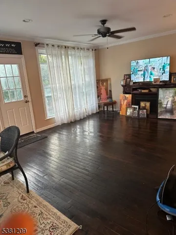 a view of a livingroom with furniture wooden floor and a window