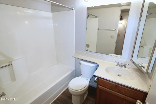 a view of a room with a chandelier fan and closet