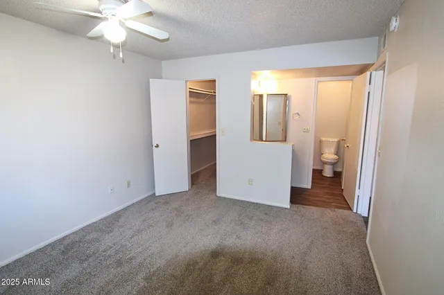 a white toilet sitting next to a shower