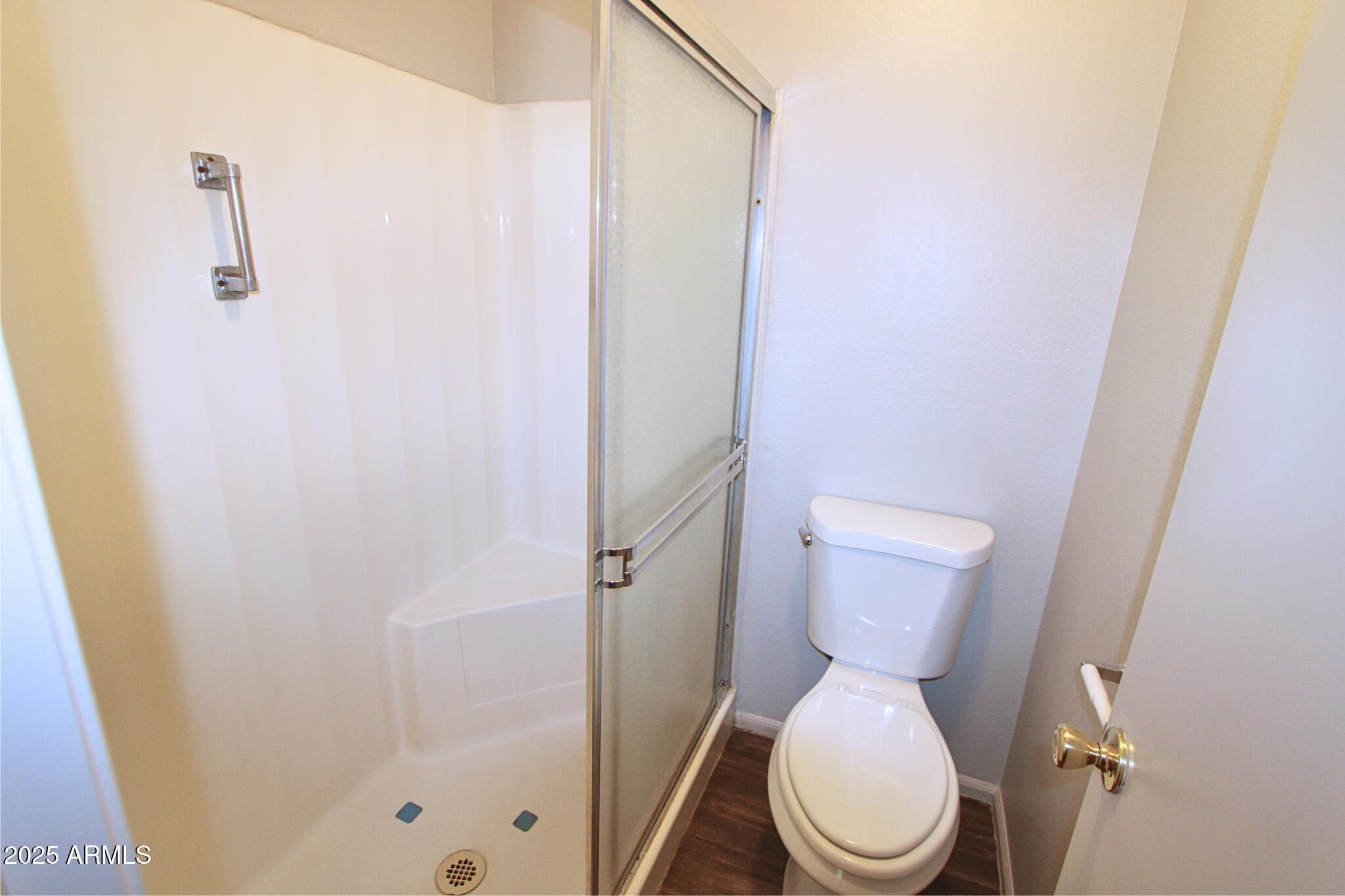 623 West Guadalupe Road, Unit 261 Mesa, AZ 85210 - Photo 15 of 24 a white toilet sitting next to a shower