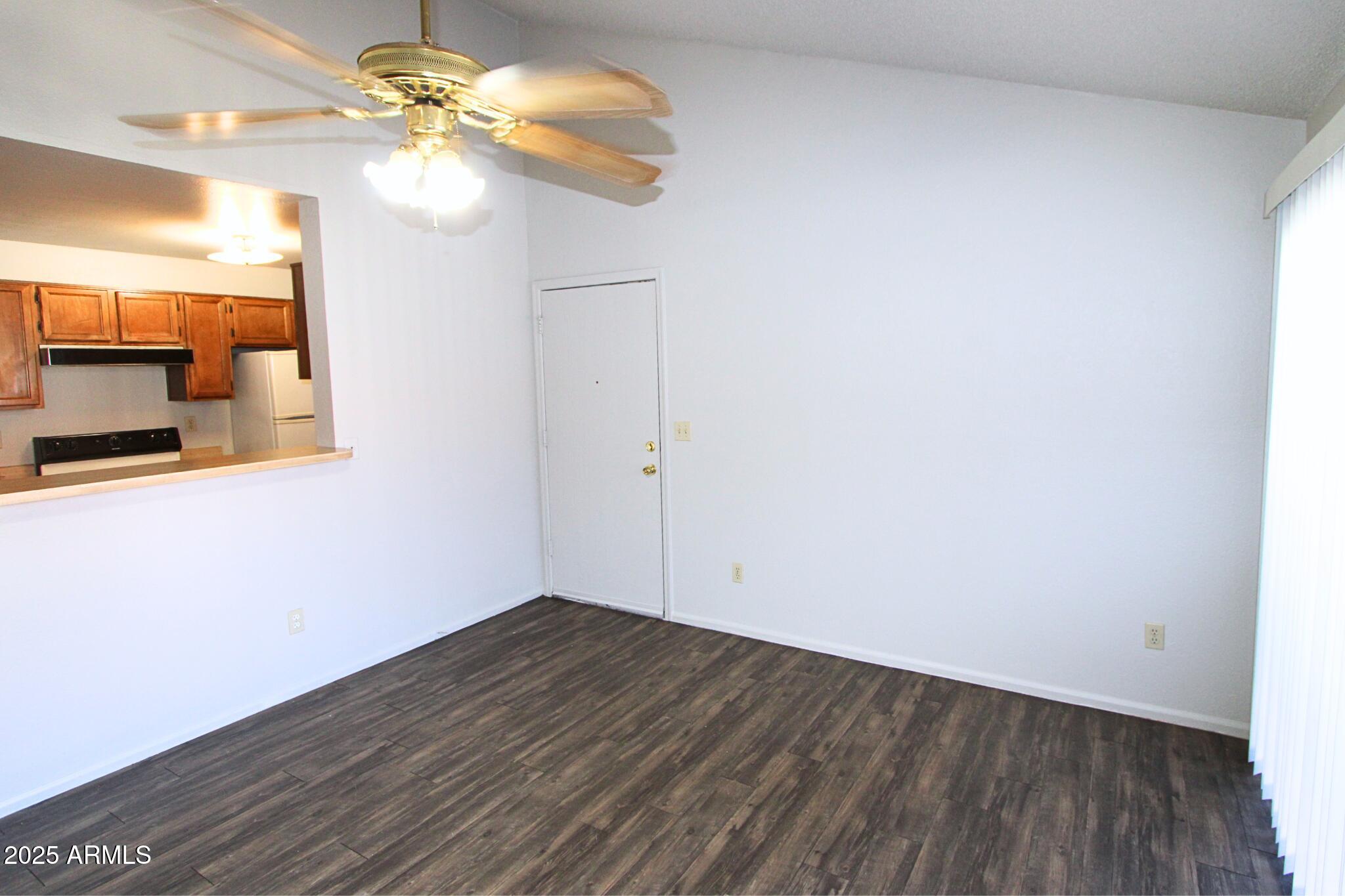 623 West Guadalupe Road, Unit 261 Mesa, AZ 85210 - Photo 2 of 24 a view of a room with wooden floor and a ceiling fan