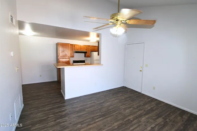 a view of a chandelier fan and wooden floor