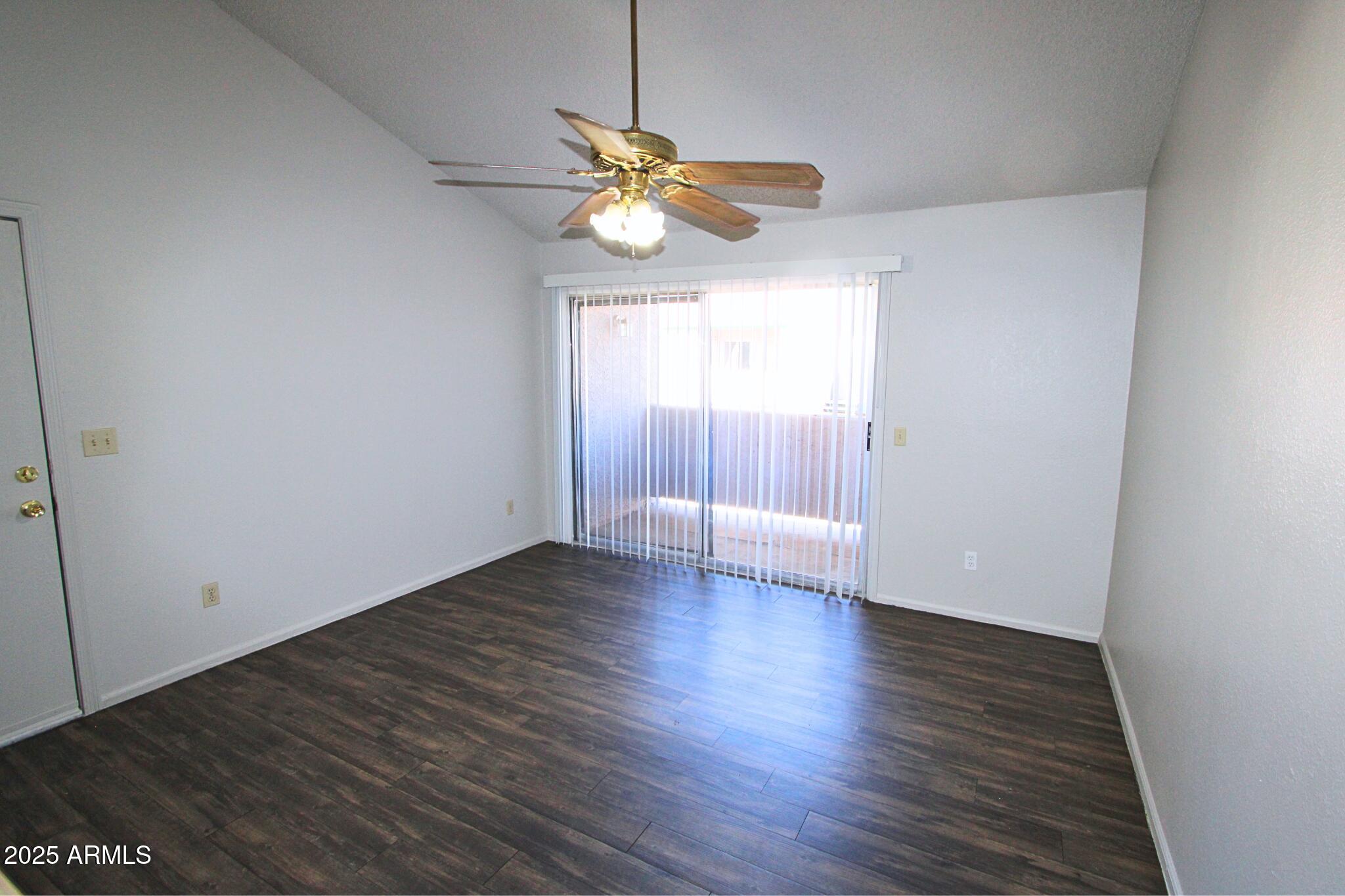 623 West Guadalupe Road, Unit 261 Mesa, AZ 85210 - Photo 7 of 24 a view of an empty room with window and wooden floor
