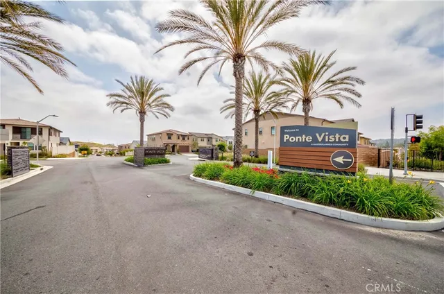 a view of a patio with couches table and chairs and potted plants
