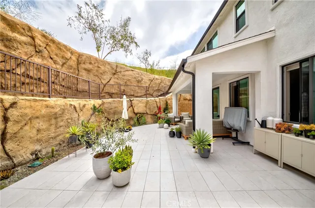 a view of a patio with couches and potted plants