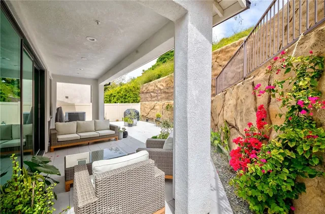 a large white kitchen with stainless steel appliances granite countertop a stove a sink dishwasher and white countertops with wooden floor