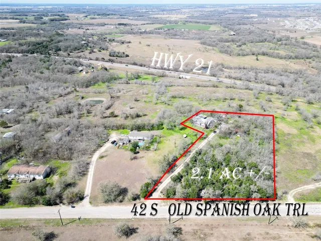 an aerial view of beach and residential houses with outdoor space