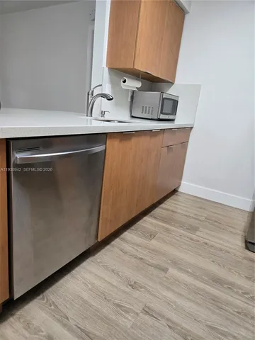 a view of storage and utility room with wooden floor