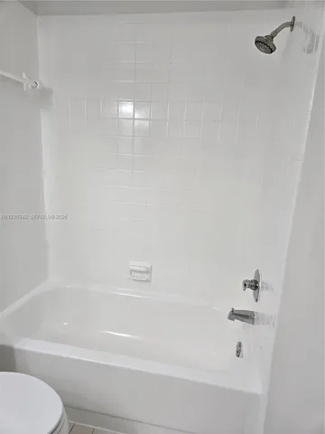 a bathroom with a toilet and a bathtub