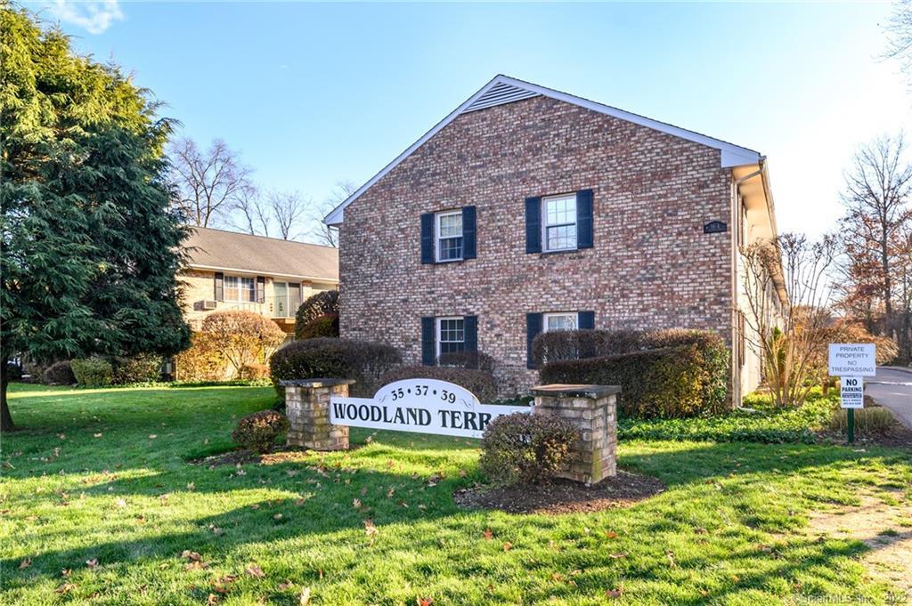 37 Woodway Road, Unit B8 Stamford, CT 06907 - Photo 1 of 1 a brick building with a yard in front of it