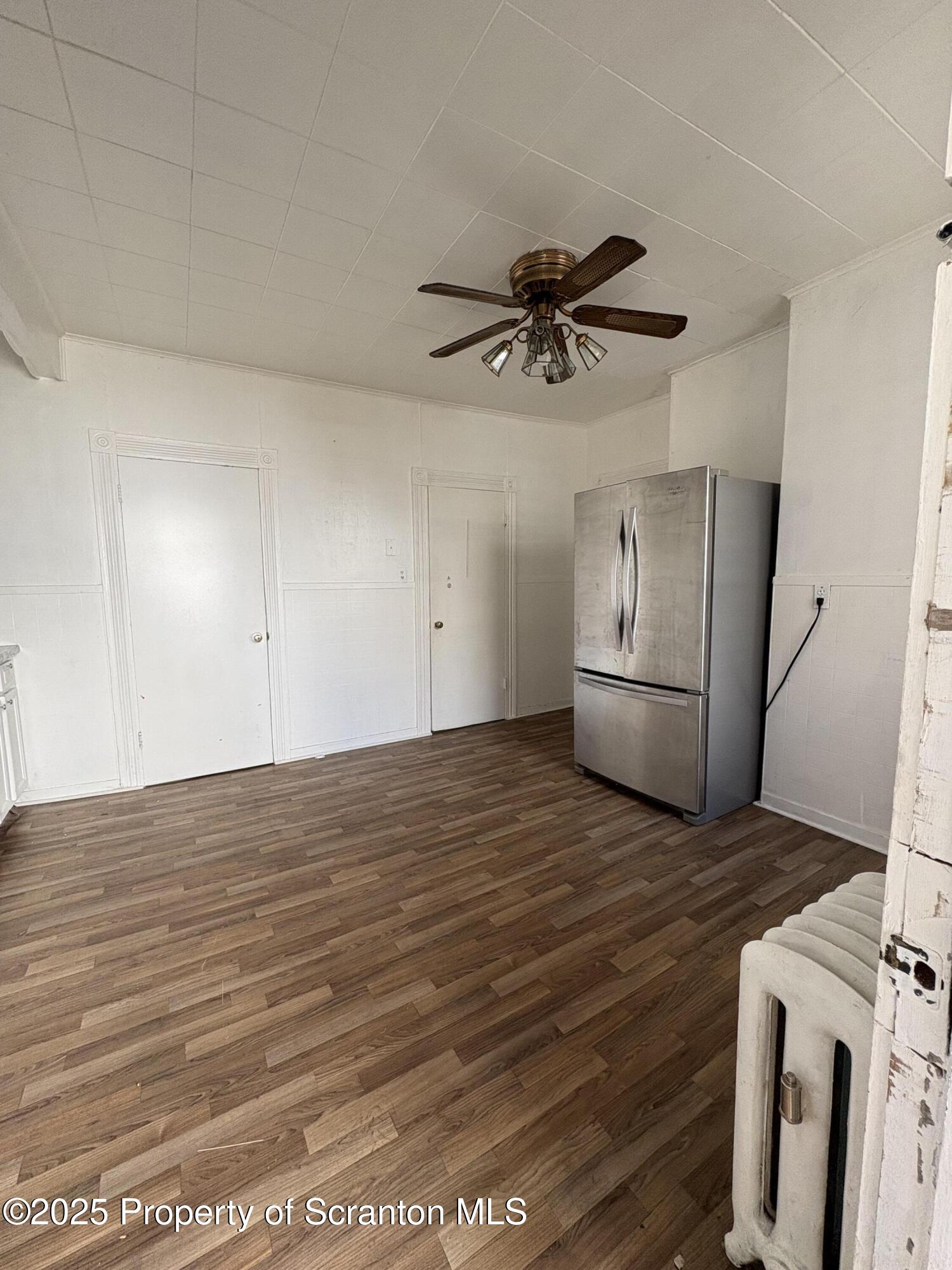 1318 North Washington Avenue Scranton, PA 18509 - Photo 4 of 11 a view of empty room with wooden floor and ceiling fan