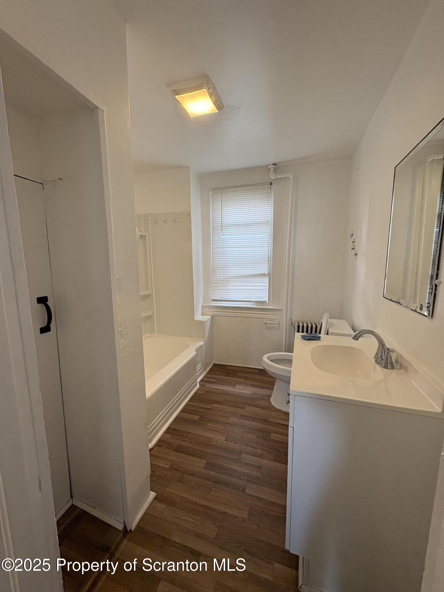 1318 North Washington Avenue Scranton, PA 18509 - Photo 10 of 11 a bathroom with a sink and a mirror