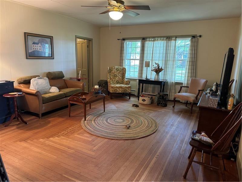 149 South Franklin Street Prospect, PA 16052 - Photo 7 of 25 a living room with furniture a fireplace and a floor to ceiling window