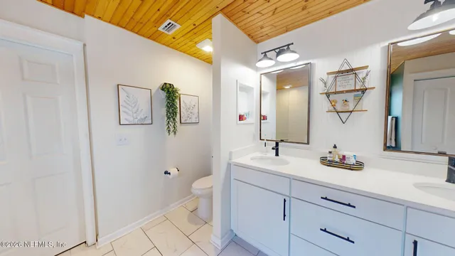 a living room with furniture and a baby crib