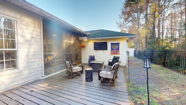 a front view of a house with a garden and tree