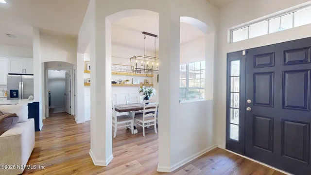 a large kitchen with cabinets a sink a stove a dining table and chairs