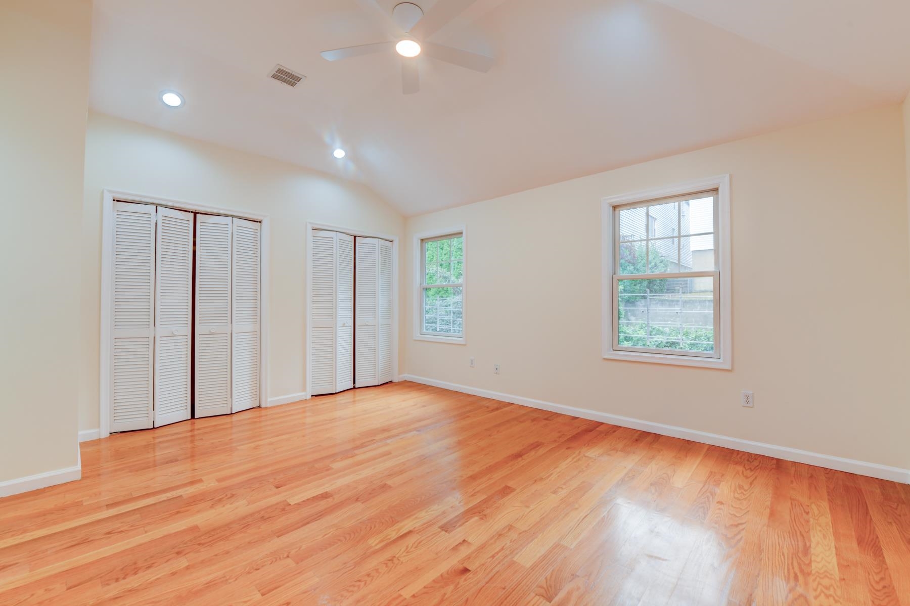 190 Terrace Avenue, Unit 2 Jersey City, NJ 07307 - Photo 19 of 29 a view of an empty room with wooden floor and a window